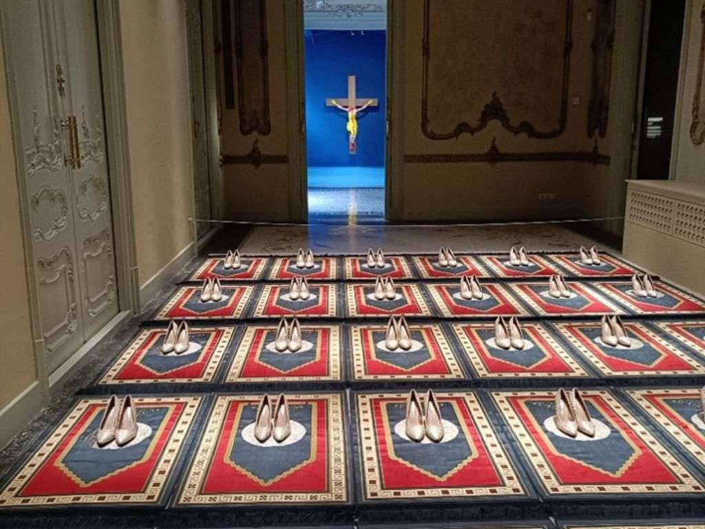 白底黑字的女性剪影，从她口中吐出的伊斯兰文字图案象征着沉默与表达。.